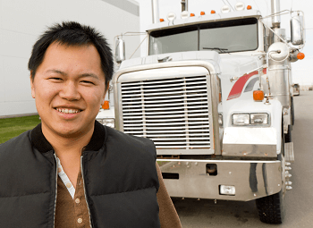 Truck driver standing in front of his commercial truck